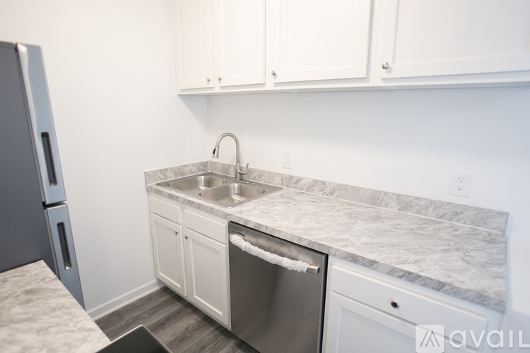 A kitchen with a sink and a dishwasher.