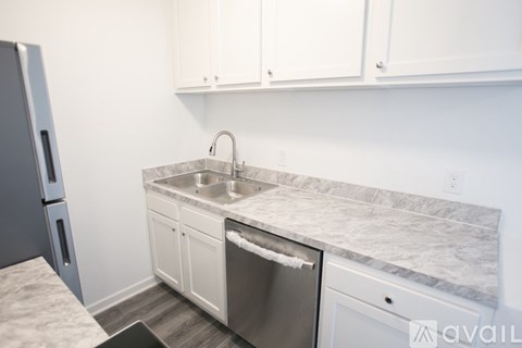 A kitchen with a sink and a dishwasher.