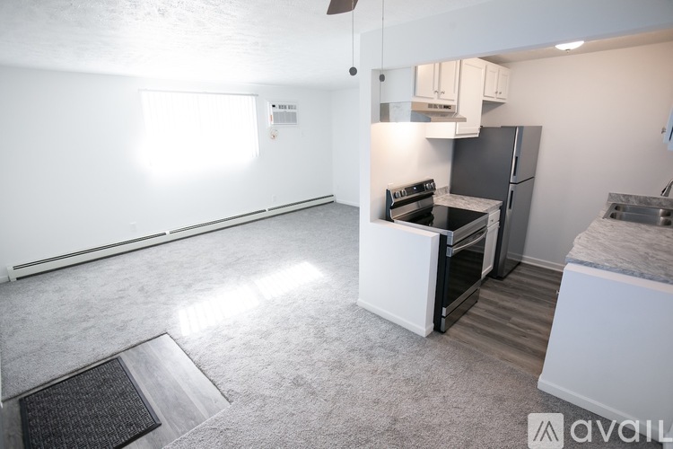 A kitchen area with a refrigerator, oven, and sink.