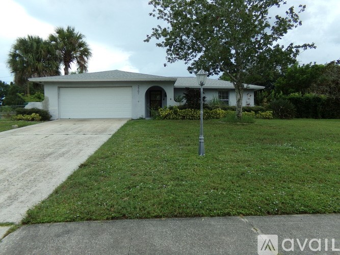 A house with a white garage door is for sale.