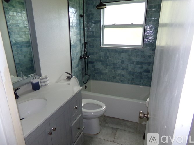 A bathroom with a toilet, sink, and shower.