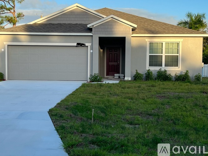 A house with a brown roof and a red door is available for sale.
