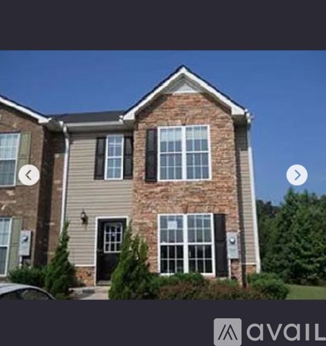 A house with a grey roof and a black door.