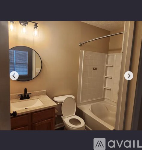 A bathroom with a toilet, sink, and shower.