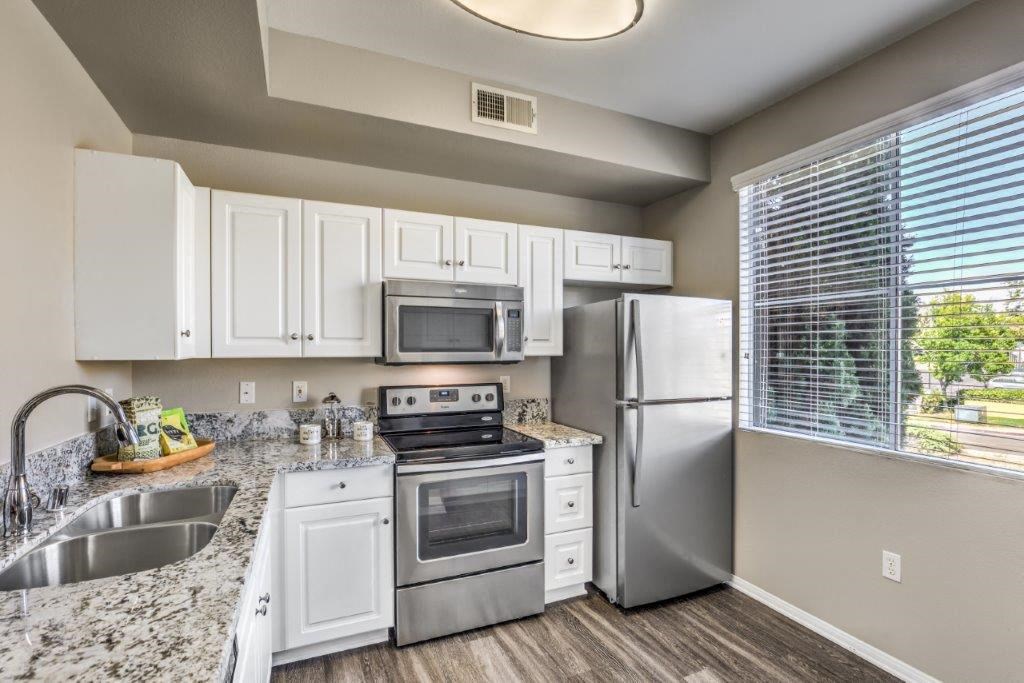 a kitchen with stainless steel appliances and white cabinets