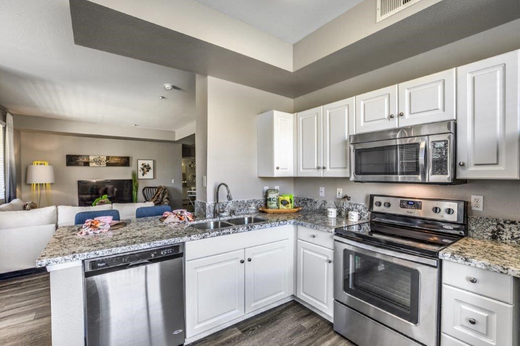 a kitchen with stainless steel appliances and granite counter tops