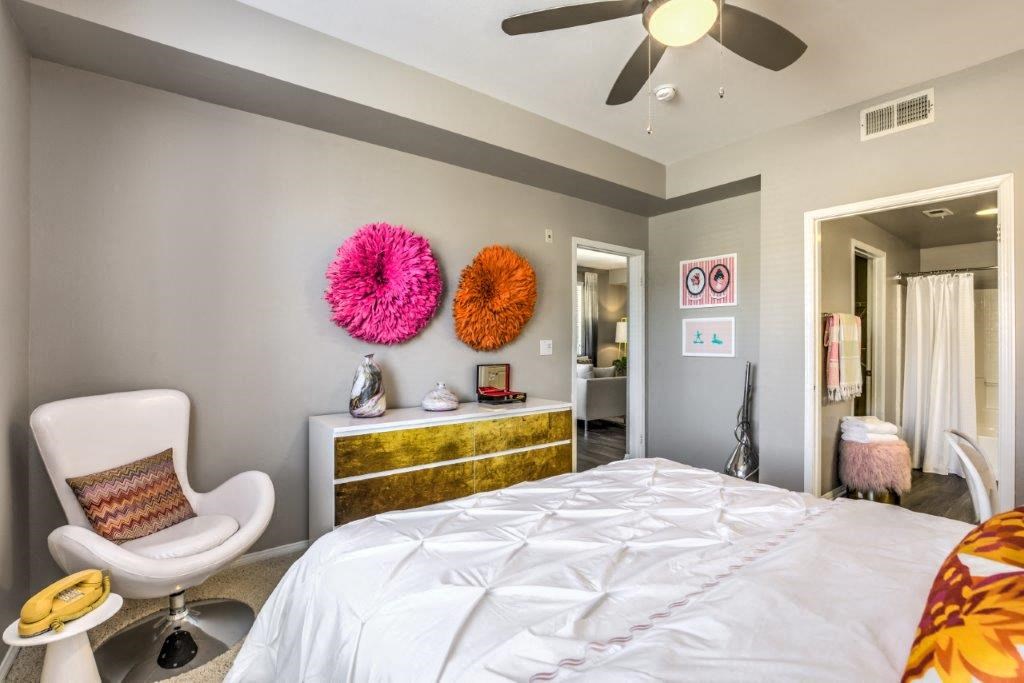 a bedroom with a large bed and a ceiling fan