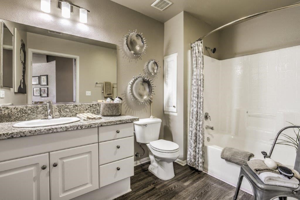 a bathroom with a toilet and a sink and a shower