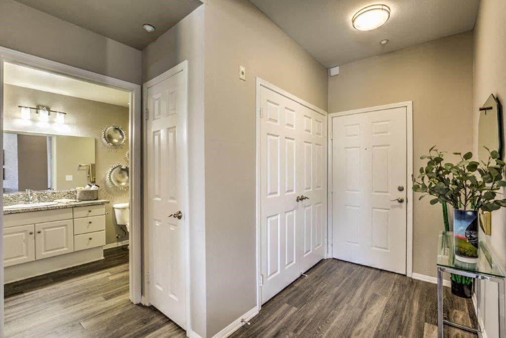 a bathroom with white doors and a sink and a mirror