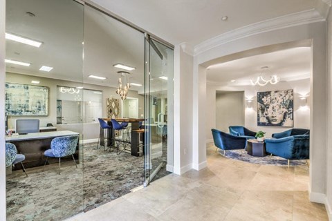 a lobby with a conference room and a table with chairs