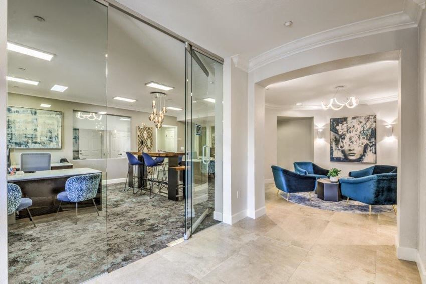 a lobby with a conference room and a table with chairs