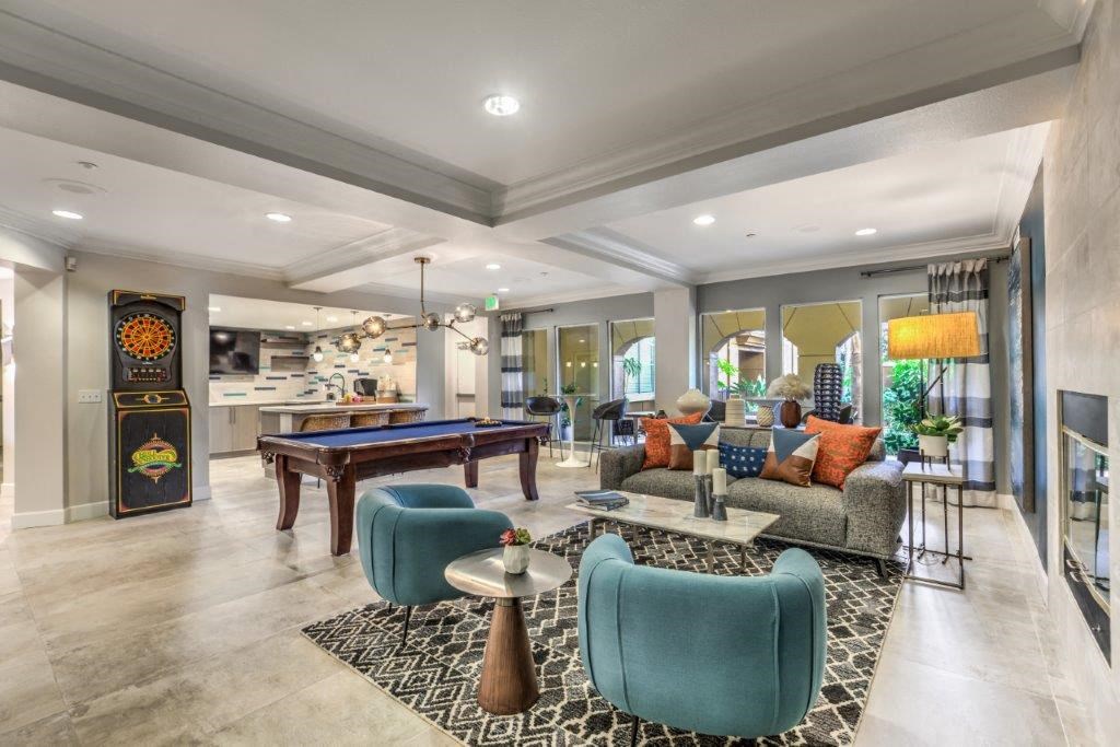 a living room with a pool table and couches