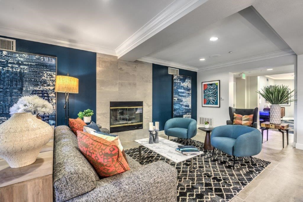 a living room with blue walls and a fireplace