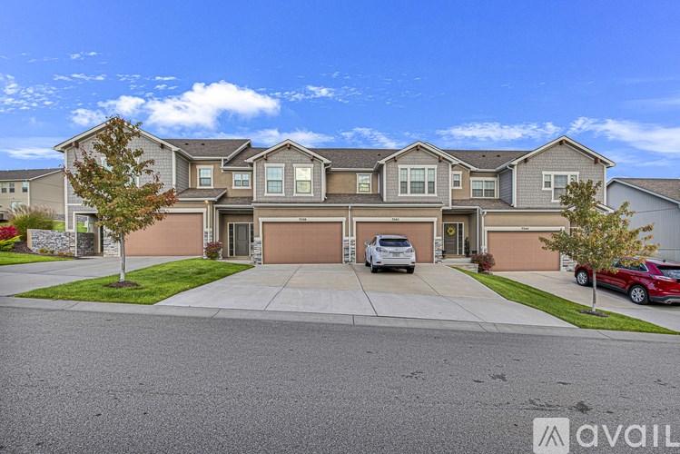A large house with a car parked in front.