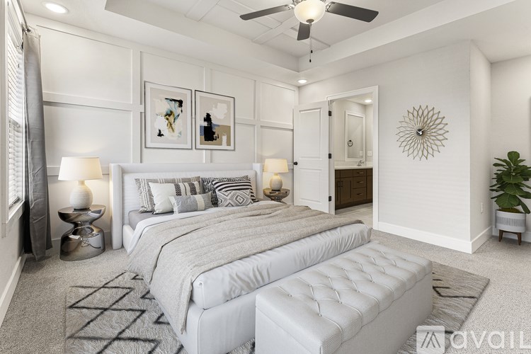 A bedroom with two beds and a ceiling fan.