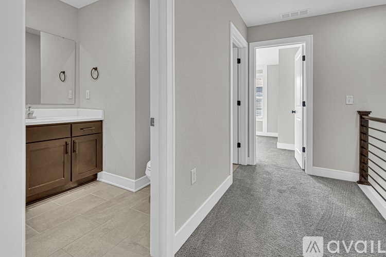 A bathroom with a sink, mirror, and wooden cabinets.