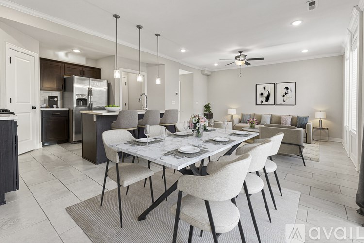 A modern dining room with a large table and chairs.