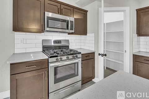 A kitchen with a stove top oven and microwave above it.