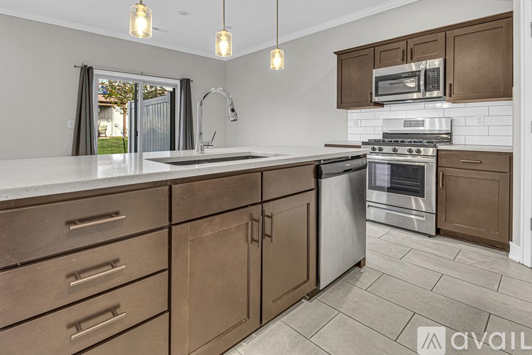 A kitchen with brown cabinets and a white countertop.