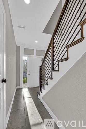 A long hallway with a staircase on the right side.