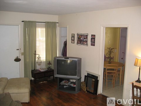 A living room with a television set and a sofa.