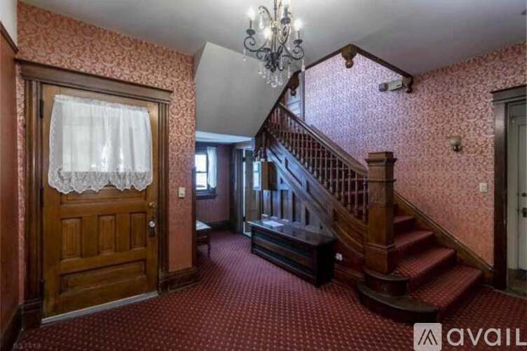A room with a staircase and a chandelier.