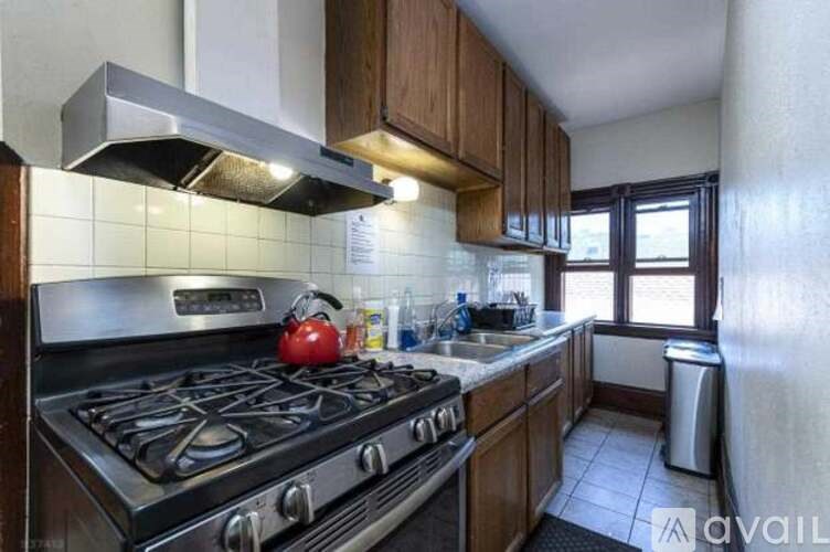 A kitchen with a stove top oven and a range hood.