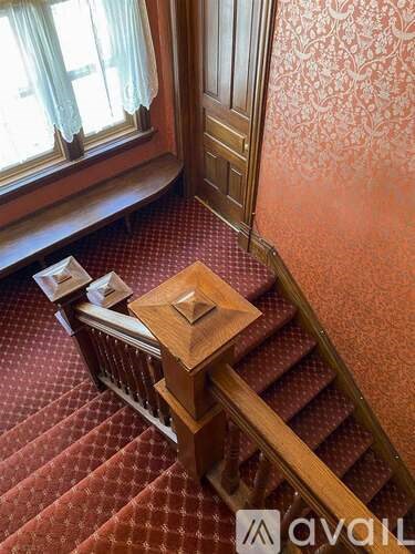 A wooden staircase with a square table in the middle.