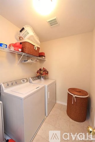 A small laundry room with a washer and dryer.