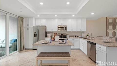 A modern kitchen with a table set for two.