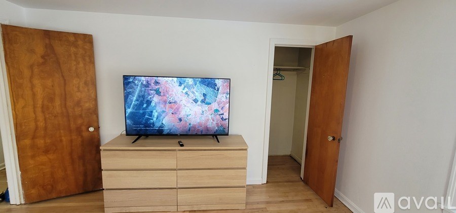 A TV is on a cabinet in a room.