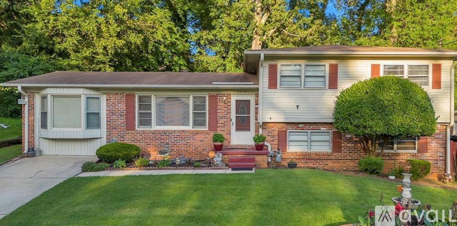 A house with a red brick exterior and a white garage door.
