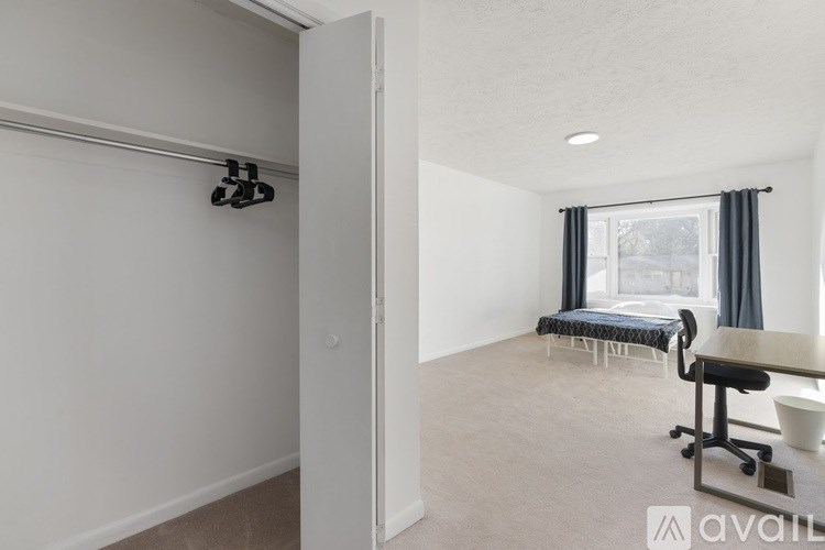 A room with a desk and chairs is available for rent.