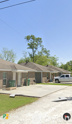 A house with a white pickup truck parked in front.