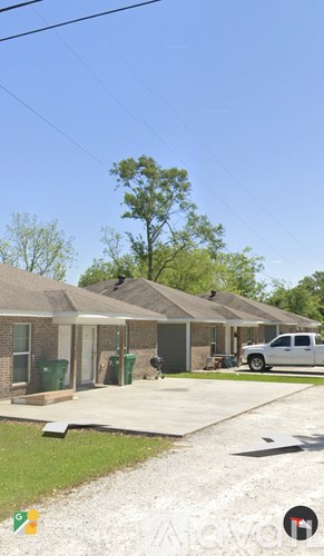 A house with a white pickup truck parked in front.