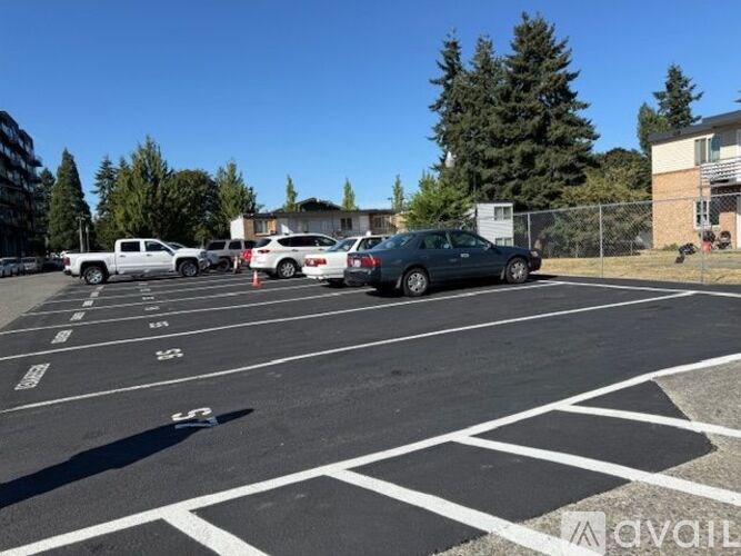 A parking lot with cars parked in the spaces.