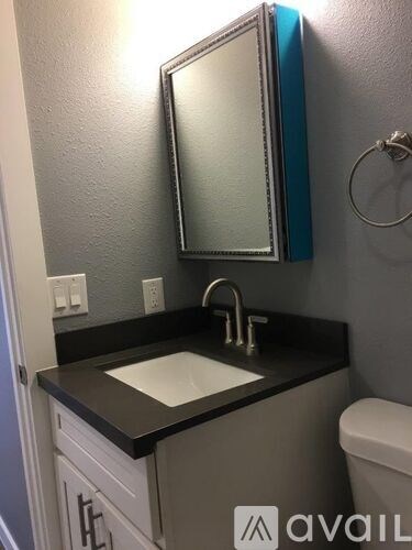 A bathroom with a sink and mirror.