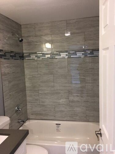 A bathroom with a tub and a shower.