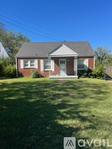 A house with a front yard and a white door.