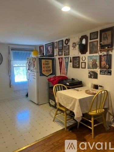 A kitchen with a table and chairs in the middle of the room.