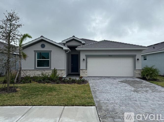 A house with a grey roof and a white garage door.