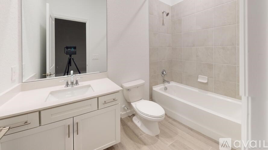 A bathroom with a white sink, toilet, and bathtub.