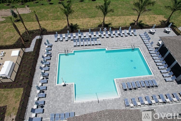 An aerial view of a swimming pool surrounded by lounge chairs.