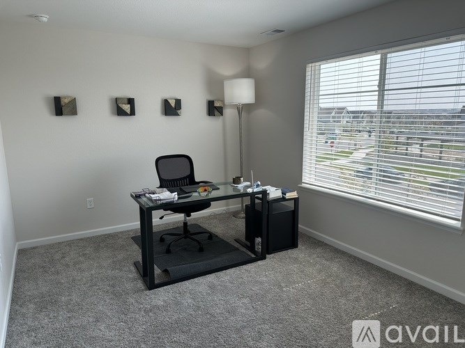 A room with a desk and a chair in it.