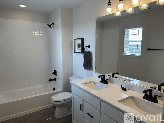 A bathroom with a white toilet, a white bathtub, and a white sink.