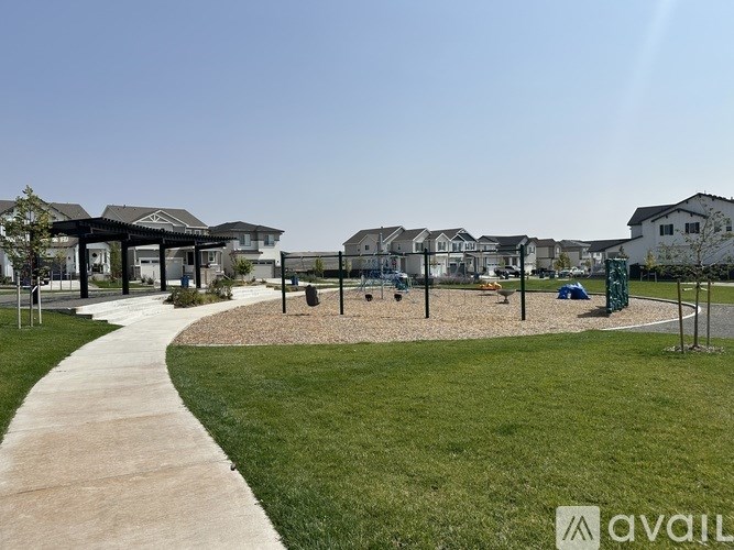 A park with a walking path and a playground area.