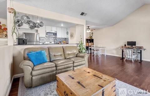 A living room with a grey couch and a wooden coffee table.
