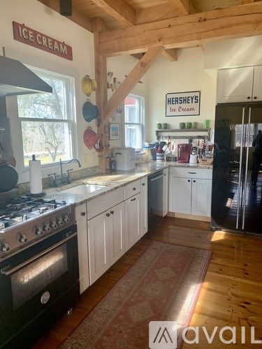 A kitchen with a stove top oven and a refrigerator.