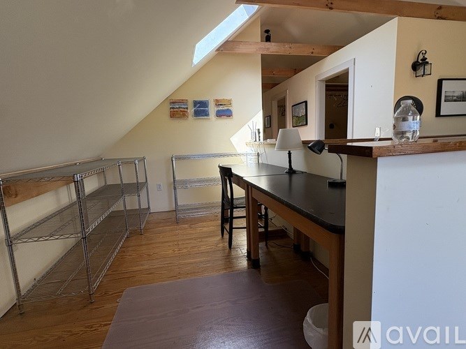 A kitchen with a brown countertop and a stainless steel refrigerator.