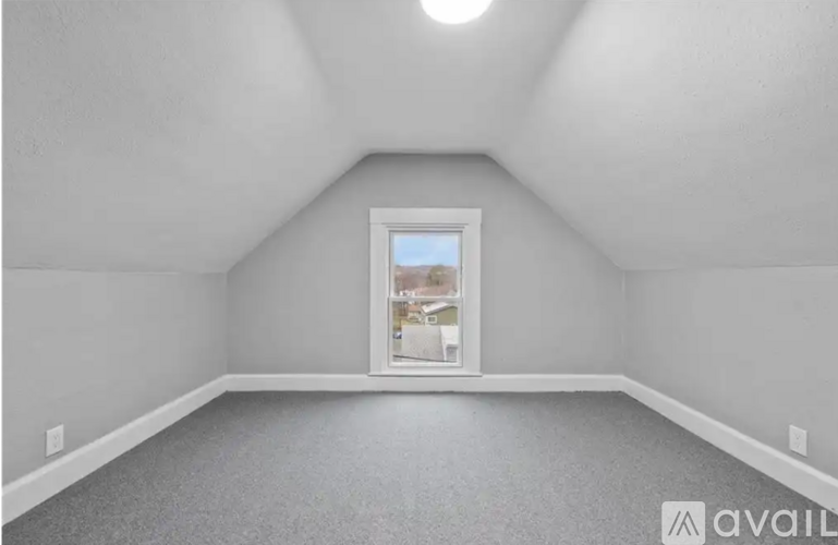 A room with a window and a view of a street.